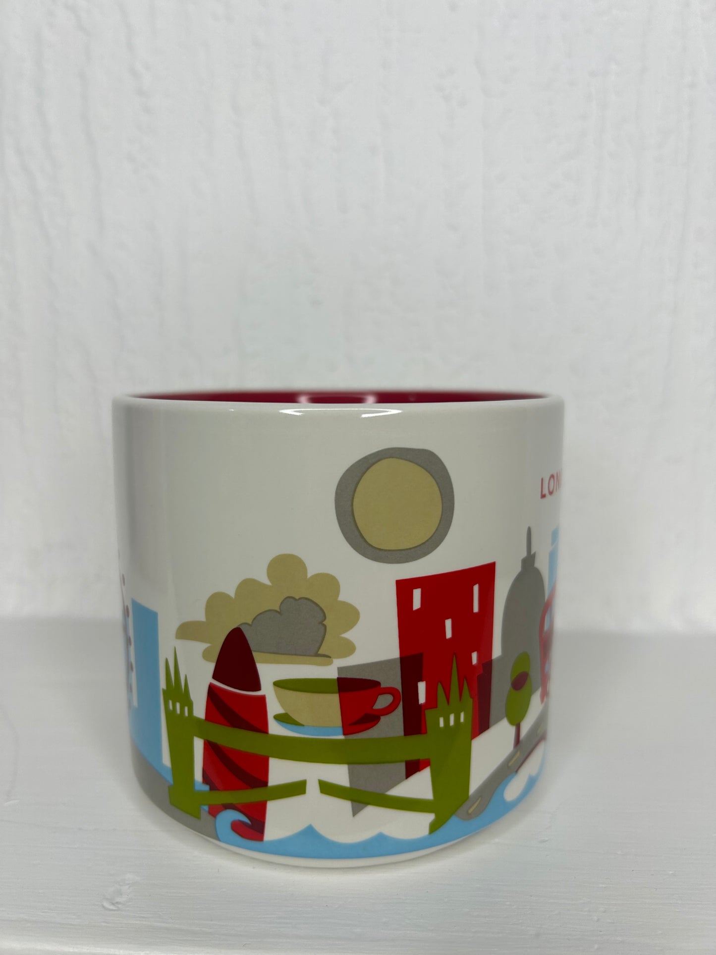 Close-up of You Are Here London Mug handle with red interior and iconic London landmarks