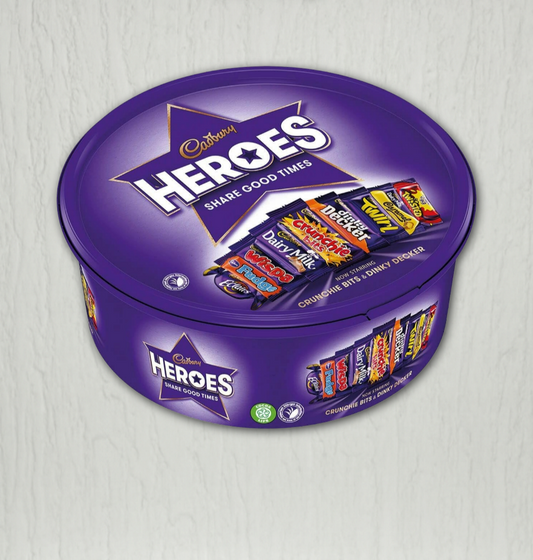 Purple Cadbury Heroes chocolate tin with candy bars on a light gray background