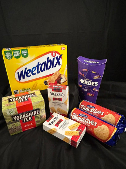 Assorted food products including Weetabix, Heroes chocolate bars, Yorkshire Tea, Walker's shortbread Fingers , and Nestle Digestives .