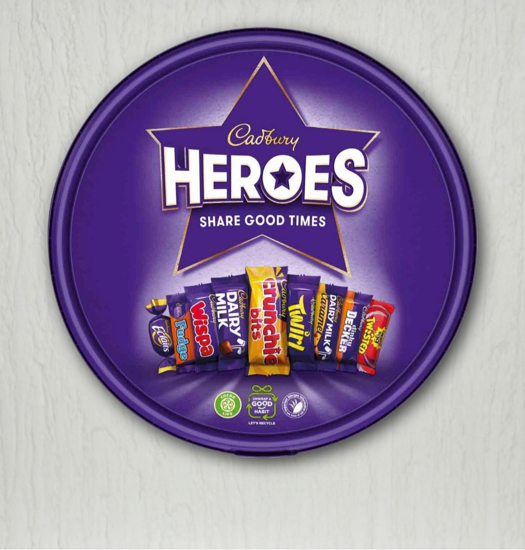 Cadbury Heroes chocolate packaging with a purple star-shaped lid on a light gray background