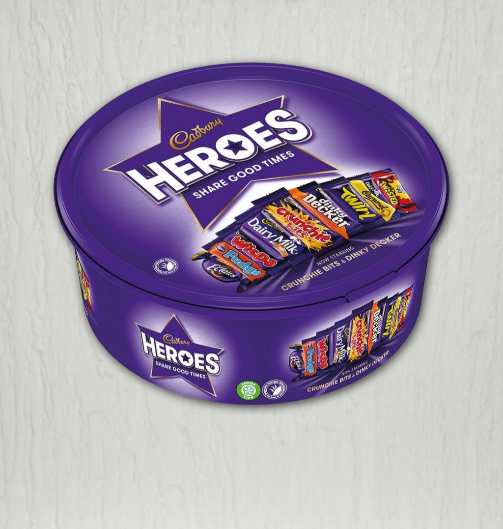 Purple Cadbury Heroes chocolate tin with candy bars on a light gray background