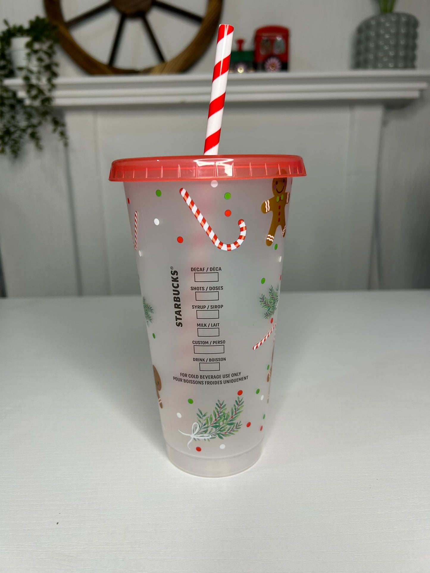Starbucks Christmas cold cup featuring gingerbread men and holiday leaves
