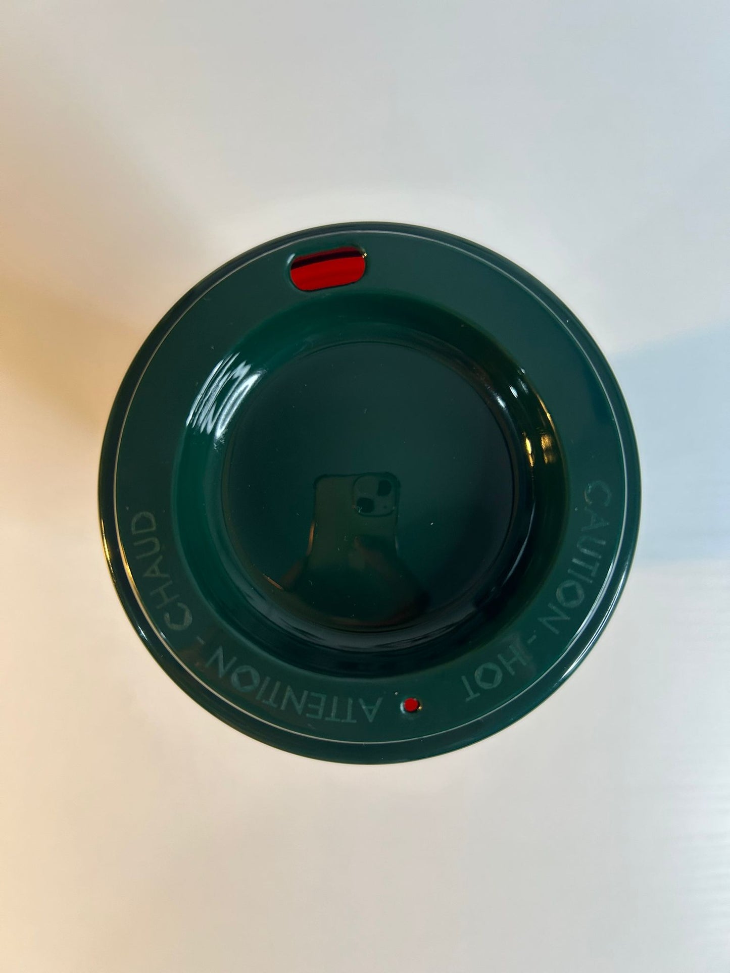 Green plastic lid with text on a white background