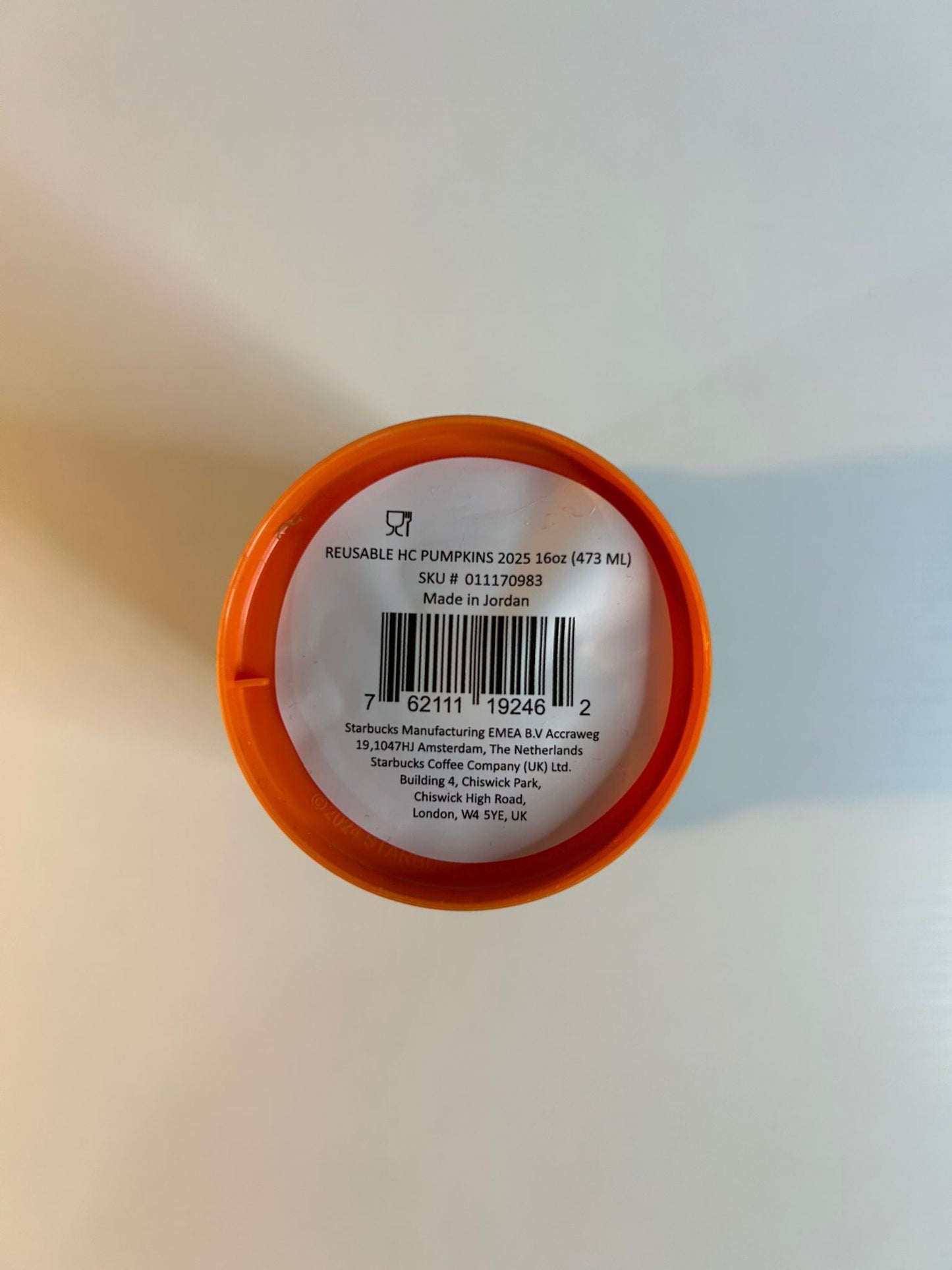 Close-up of a product label with an orange rim on a white background & Starbucks reusable Halloween coffee cup 16oz perfect for hot and cold drinks
