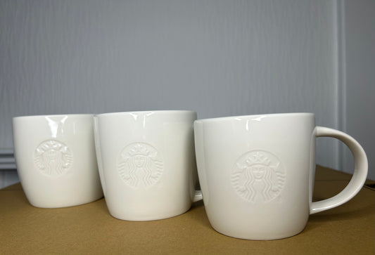 Side profile of Starbucks White Grande Mug with embossed logo